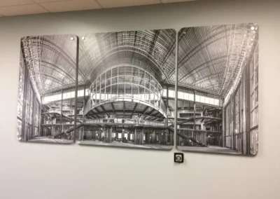 Large black and white photograph of interior architecture under construction. Photo is split into 3 panels and mounted.