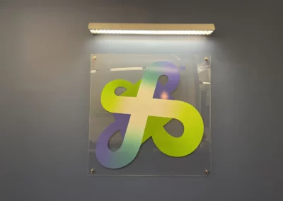 Artistic logo colored in green and purple.